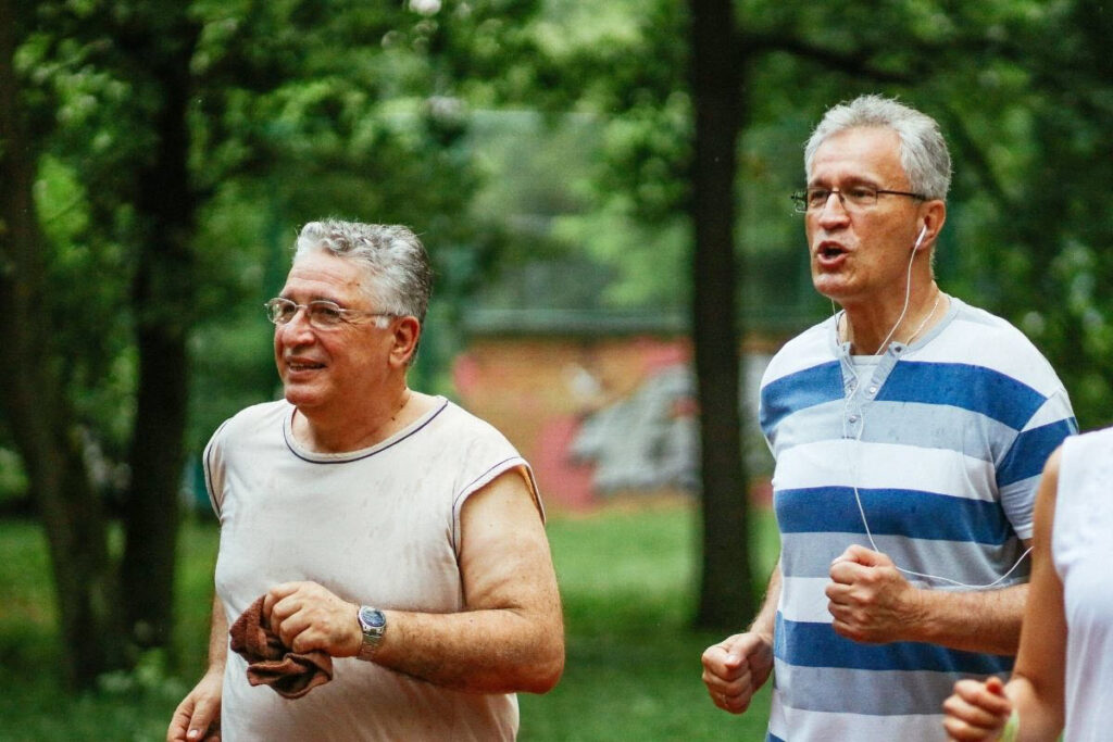 Two older men jogging to improve fitness