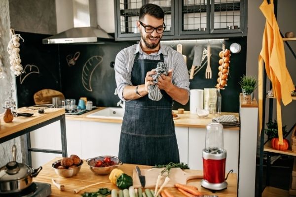 man cooking and cleaning