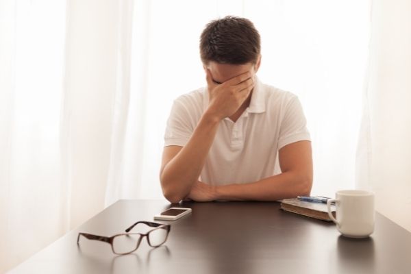 man feeling overwhelmed by life